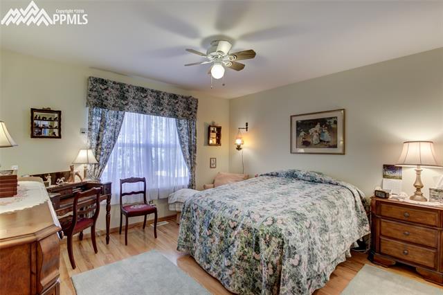 3639 Indigo Ridge Point Colorado Springs, CO 80910 - Photo 12 of 17 Spacious master bedroom with hardwood and ceiling fan