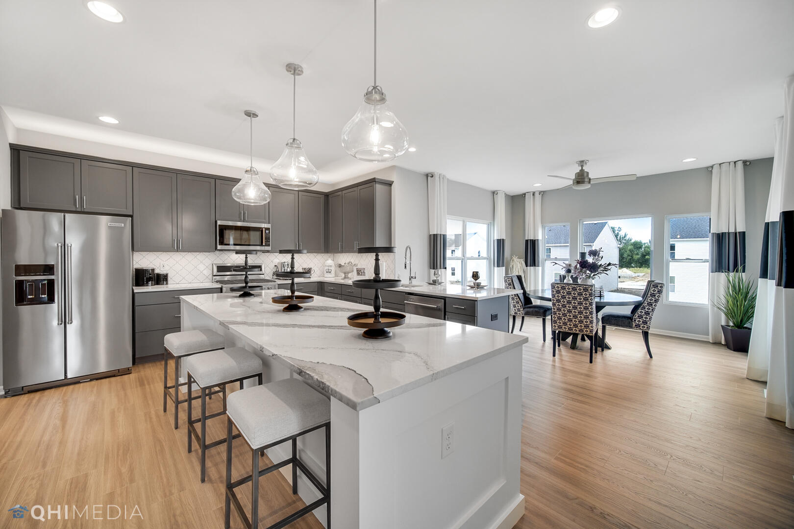 25 Levanno Drive Crown Point, IN 46307 - Photo 13 of 25 a view of a dining room kitchen island with stainless steel appliances refrigerator dining table and chairs