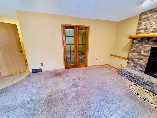 a view of an empty room with a fireplace
