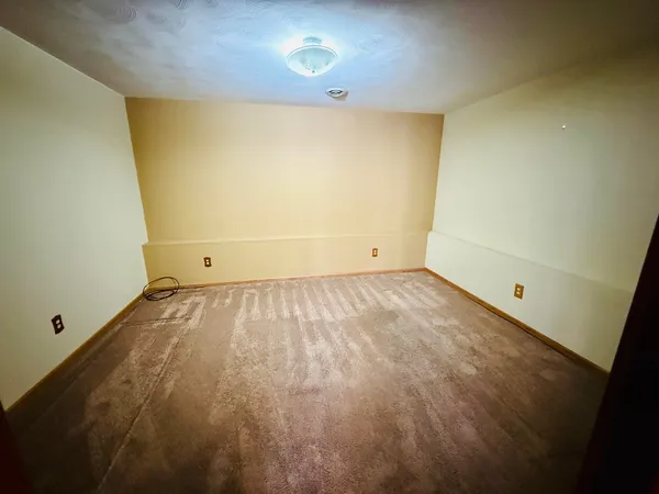 an empty room with wooden floor