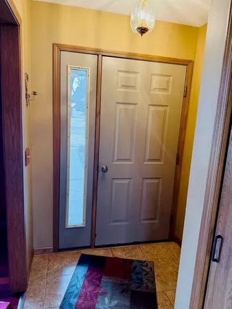 a view of front door with wooden floor