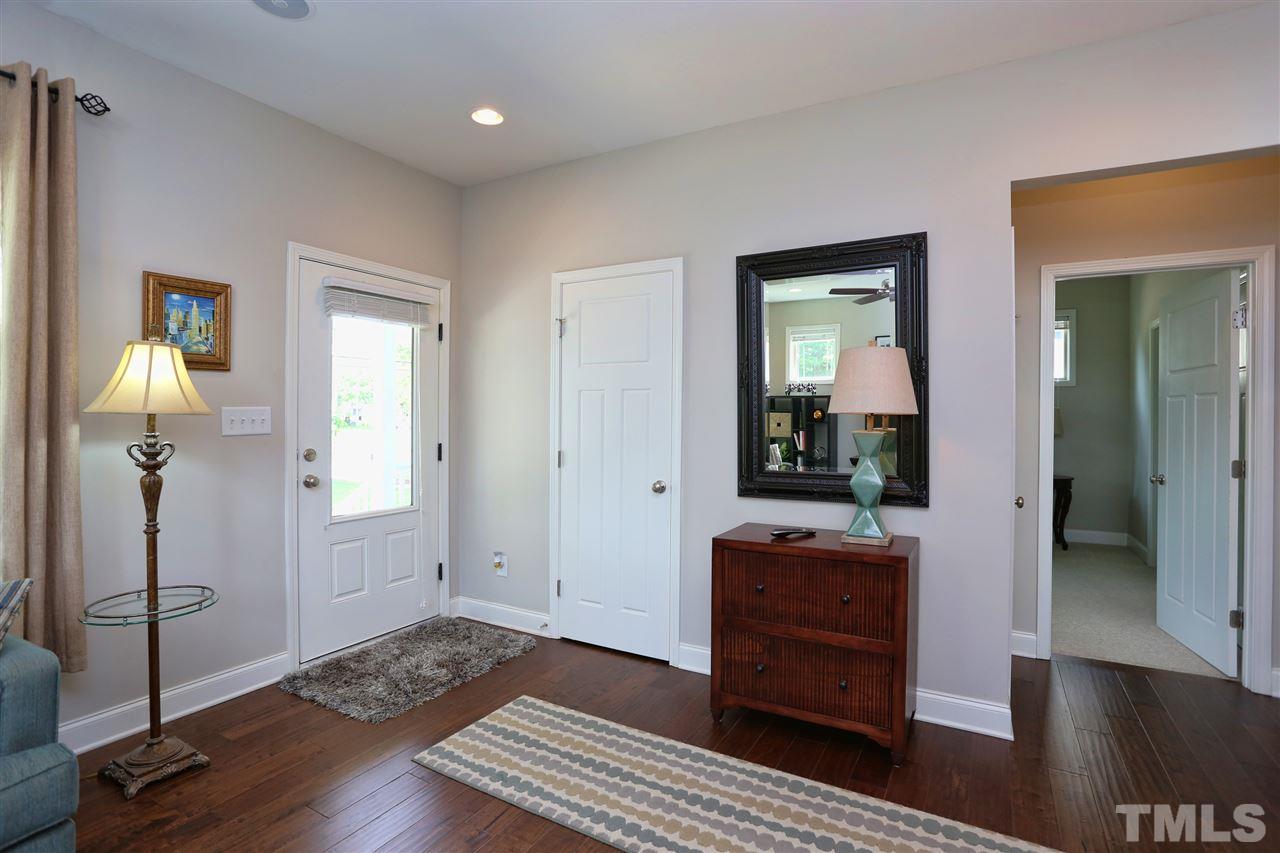 2310 Milburnie Road Raleigh, NC 27610 - Photo 11 of 25 a view of a hallway with wooden floor and furniture