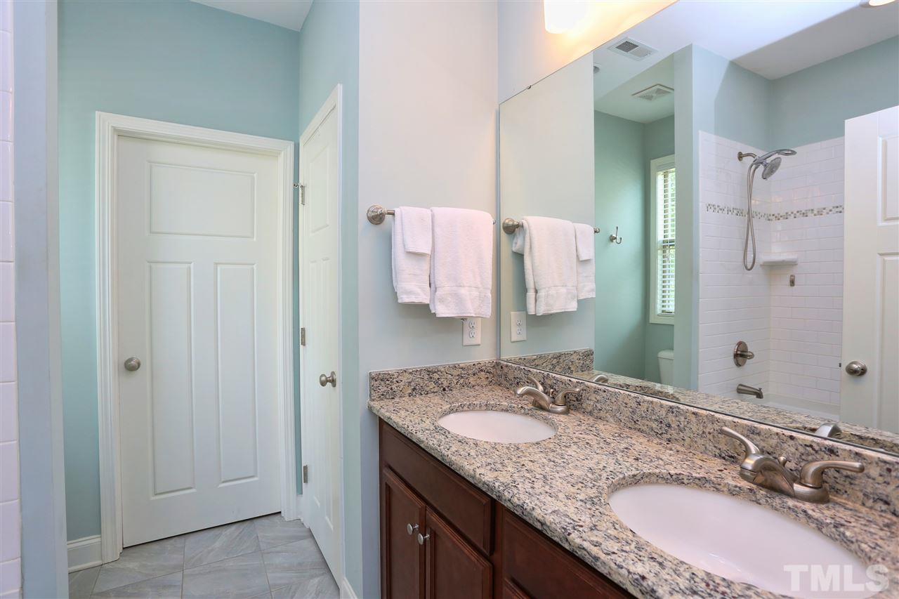 2310 Milburnie Road Raleigh, NC 27610 - Photo 14 of 25 a bathroom with a granite countertop double vanity sink and mirror