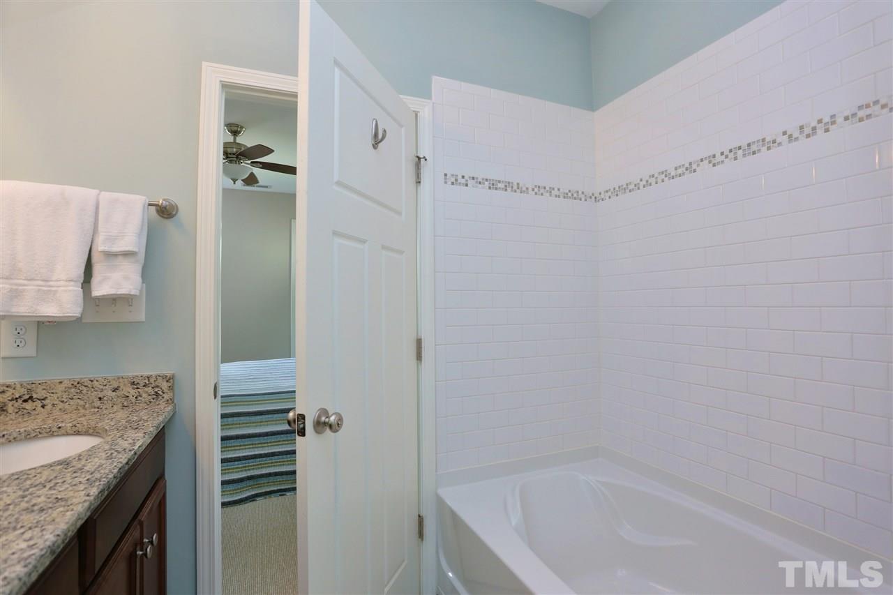 2310 Milburnie Road Raleigh, NC 27610 - Photo 15 of 25 a bathroom with a granite countertop sink and shower