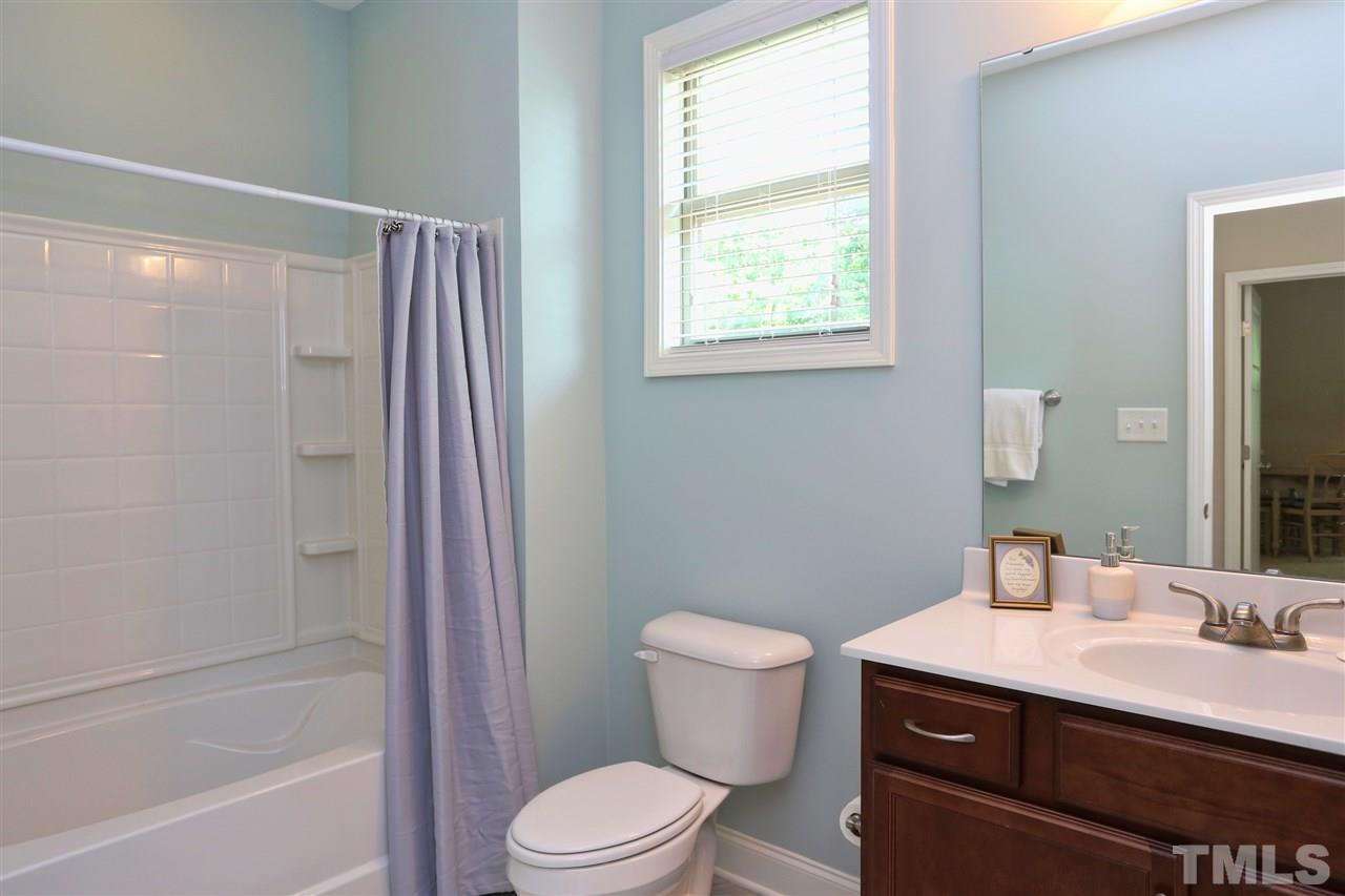 2310 Milburnie Road Raleigh, NC 27610 - Photo 17 of 25 a bathroom with a sink a toilet and shower