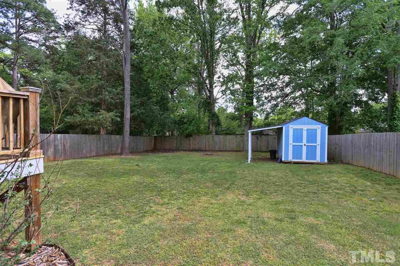 2310 Milburnie Road Raleigh, NC 27610 - Photo 23 of 25 a backyard of a house with lots of green space
