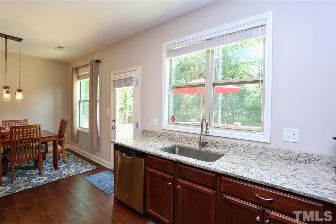 2310 Milburnie Road Raleigh, NC 27610 - Photo 6 of 25 a kitchen with granite countertop a sink a counter top space and dining table