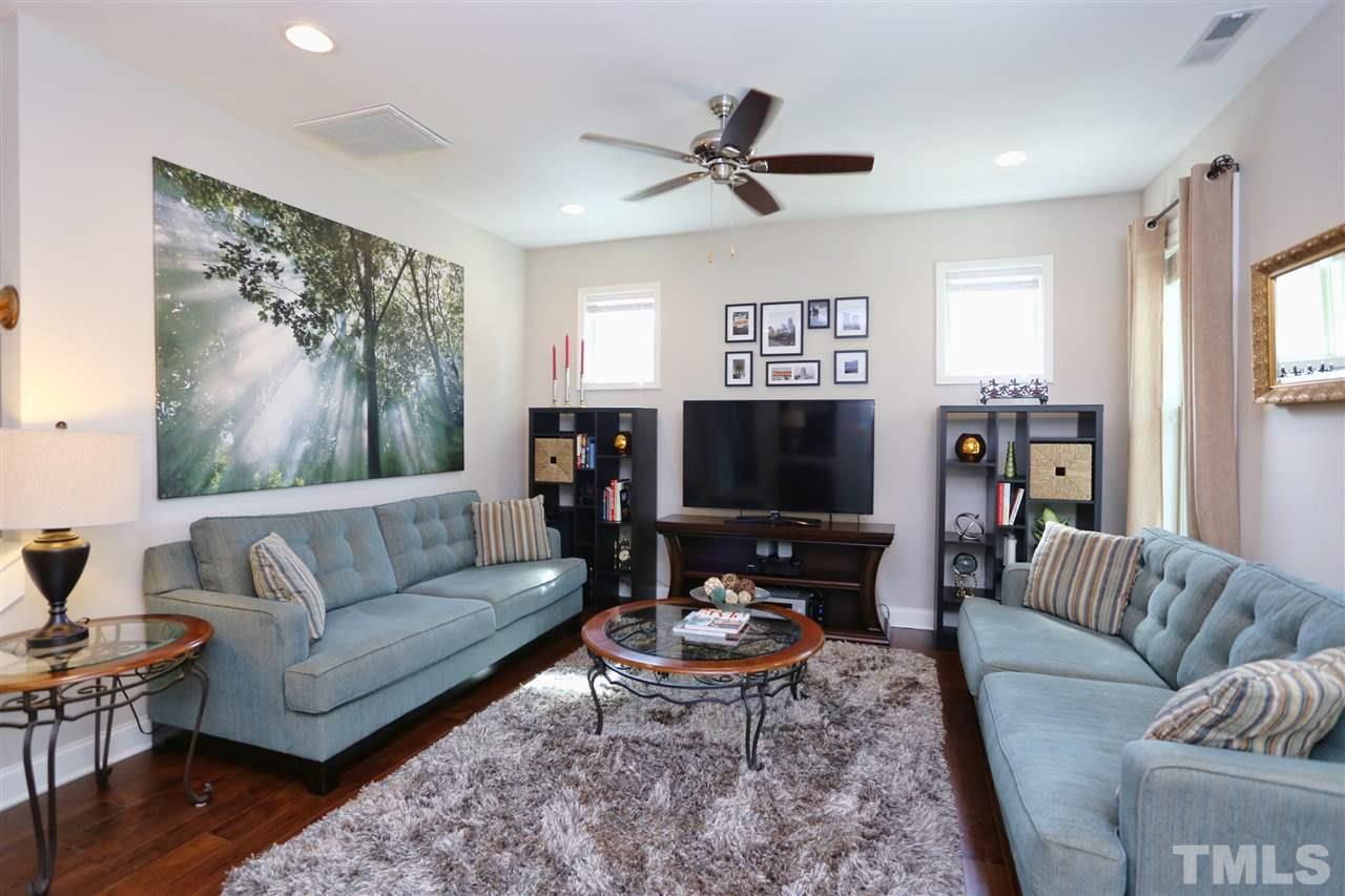 2310 Milburnie Road Raleigh, NC 27610 - Photo 10 of 25 a living room with furniture a rug and a flat screen tv