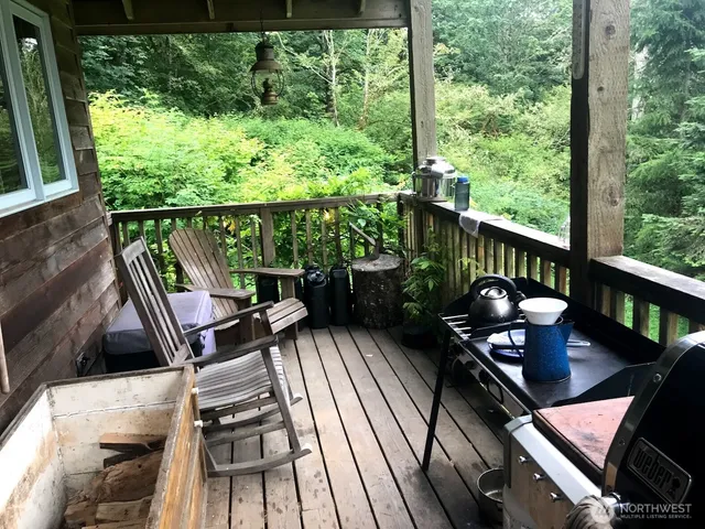 a view of a patio with lawn chairs