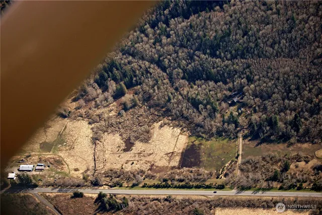 a view of a yard with wooden fence