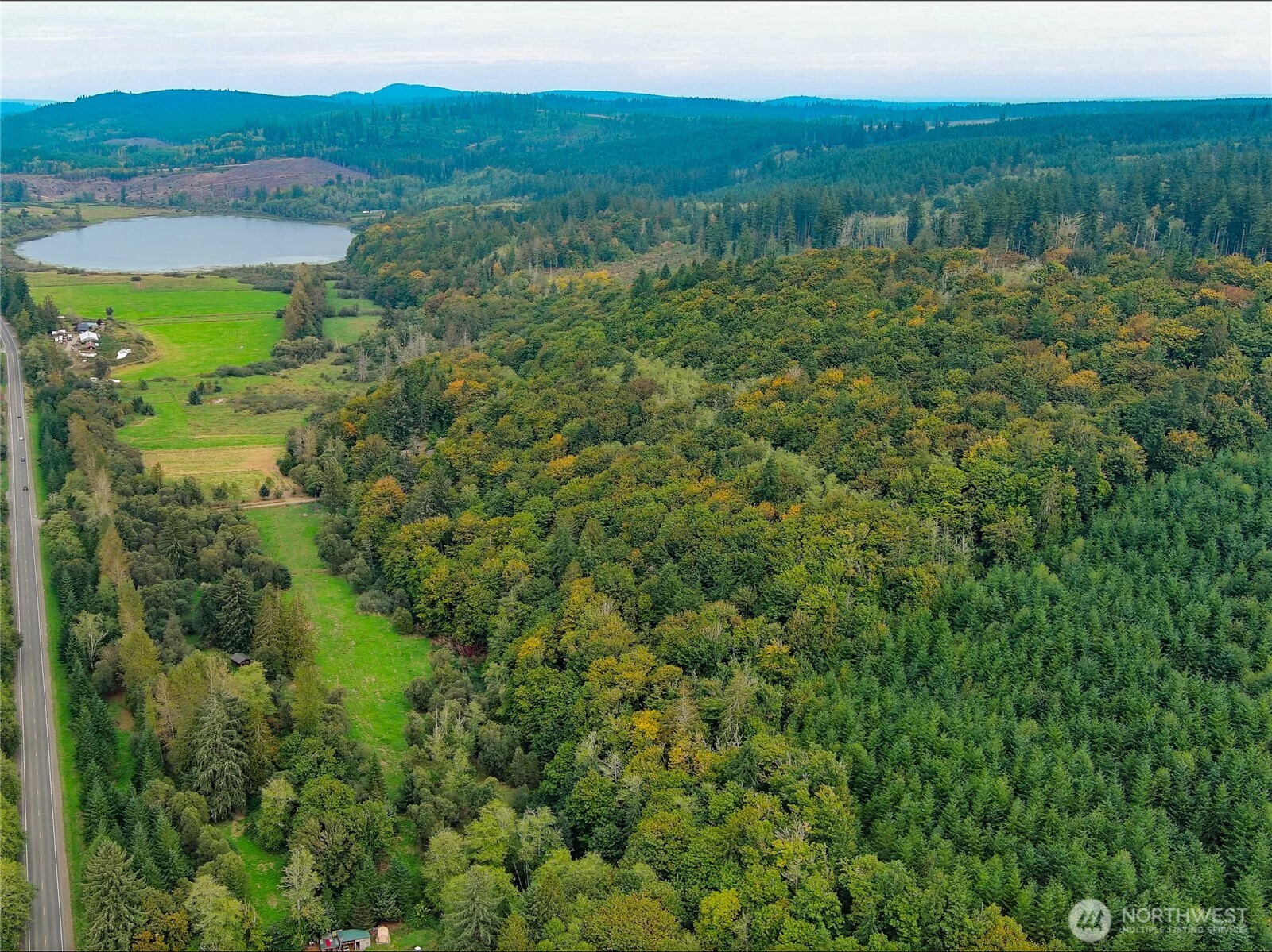 106 Crocker Lake Road Quilcene, WA 98376 - Photo 3 of 34 a view of a lake with a field of the house