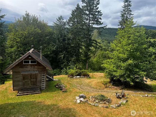 a view of a wooden house with a yard