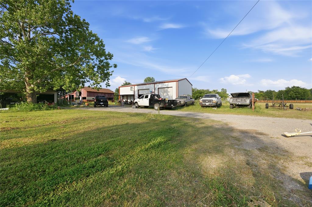2449 East Fm 120 Denison, TX 75021 - Photo 2 of 30 a view of a house with a big yard and many trees