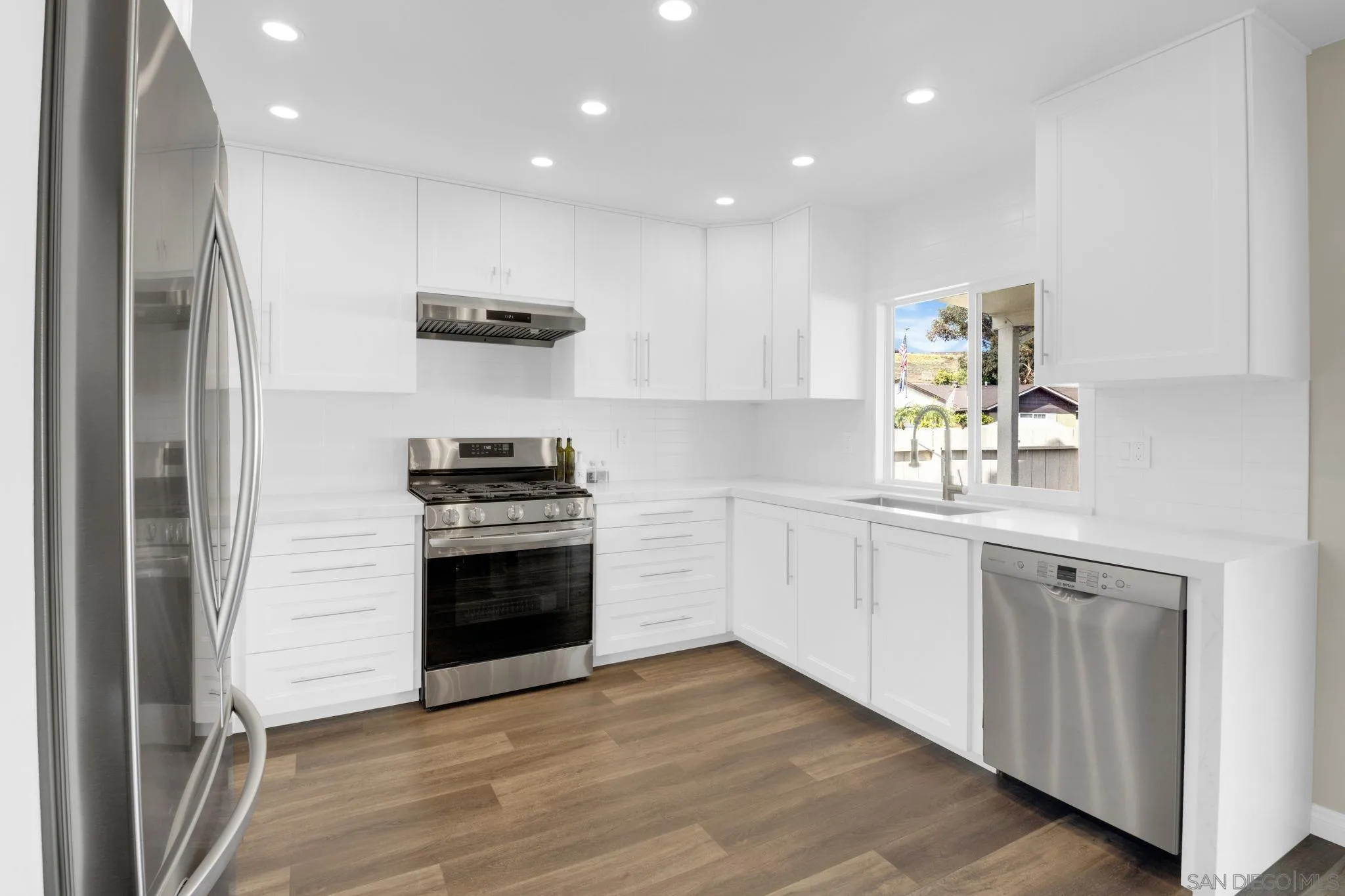 12408 Laja Drive Poway, CA 92064 - Photo 12 of 41 a kitchen with stainless steel appliances a stove and a refrigerator