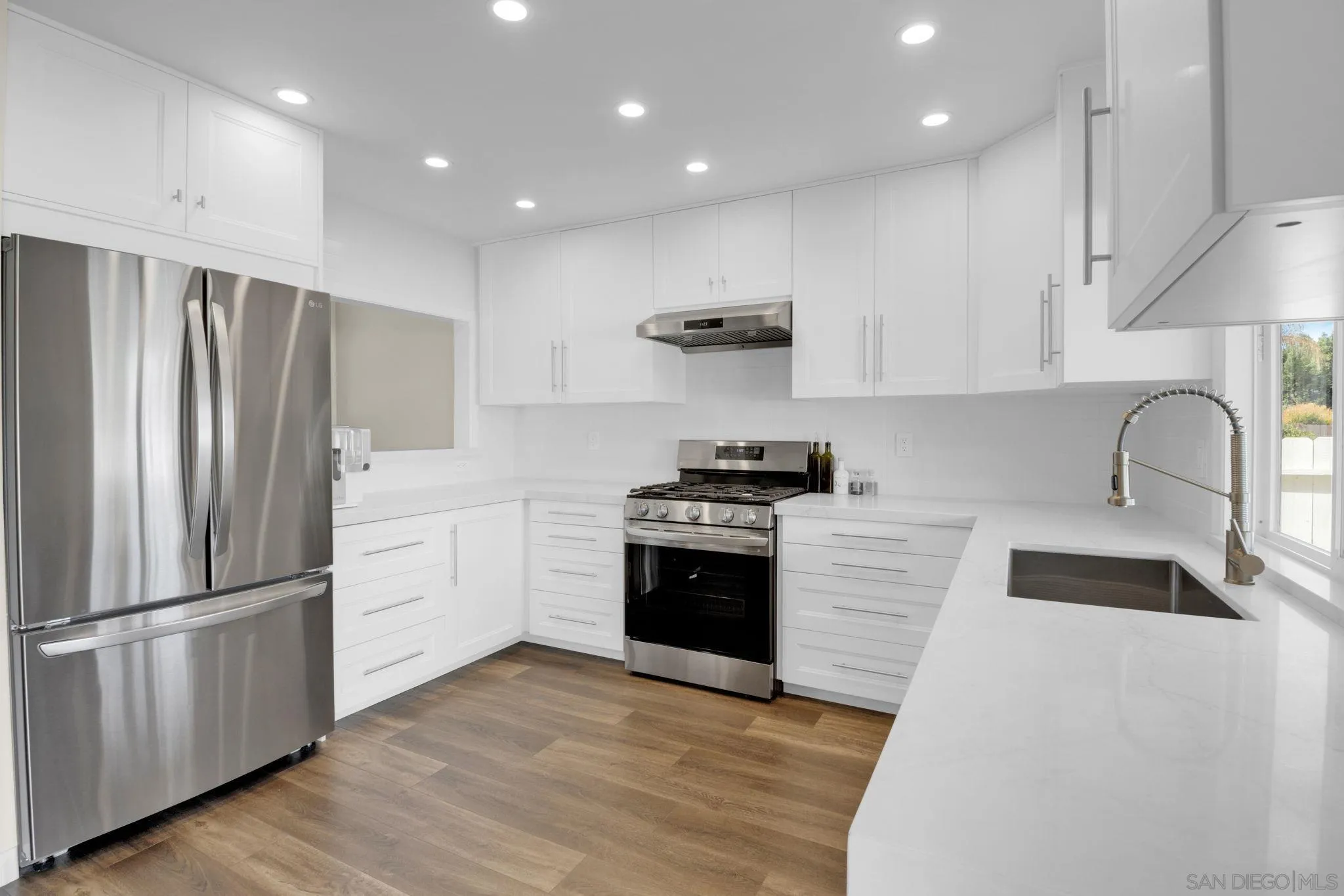 12408 Laja Drive Poway, CA 92064 - Photo 14 of 41 a kitchen with granite countertop a refrigerator stove and sink