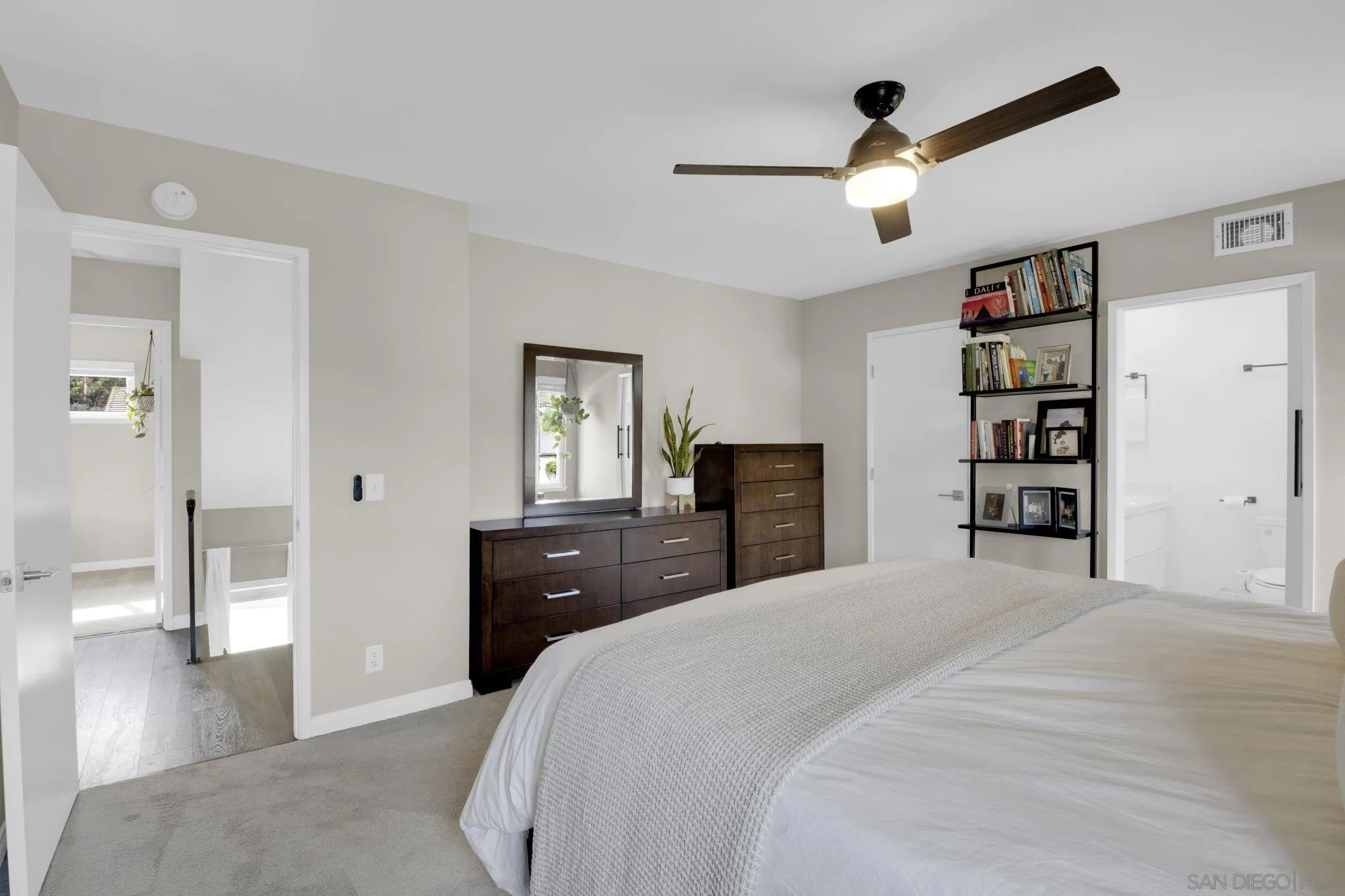 12408 Laja Drive Poway, CA 92064 - Photo 25 of 41 a bedroom with a large bed and a chandelier