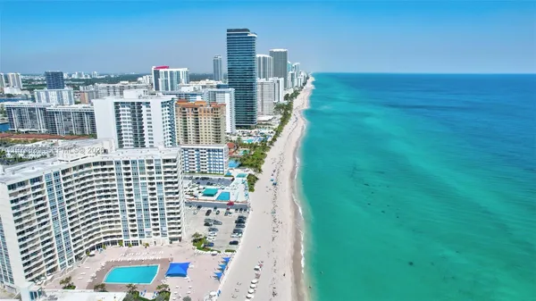 a living room with furniture a flat screen tv and a large window