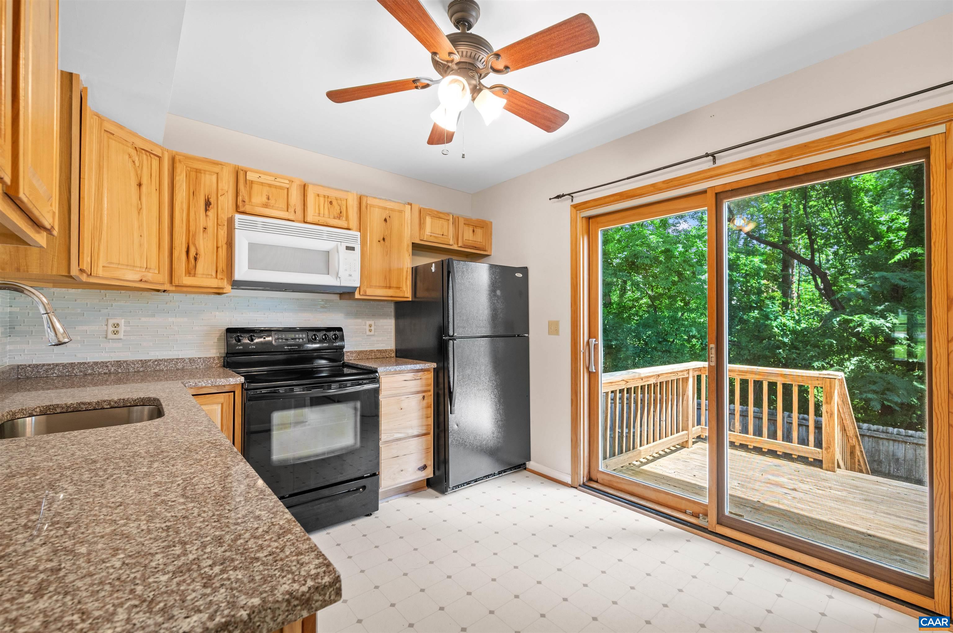1616 Cool Spring Road Charlottesville, VA 22901 - Photo 11 of 38 a kitchen with stainless steel appliances granite countertop a stove a refrigerator and a sink with cabinets