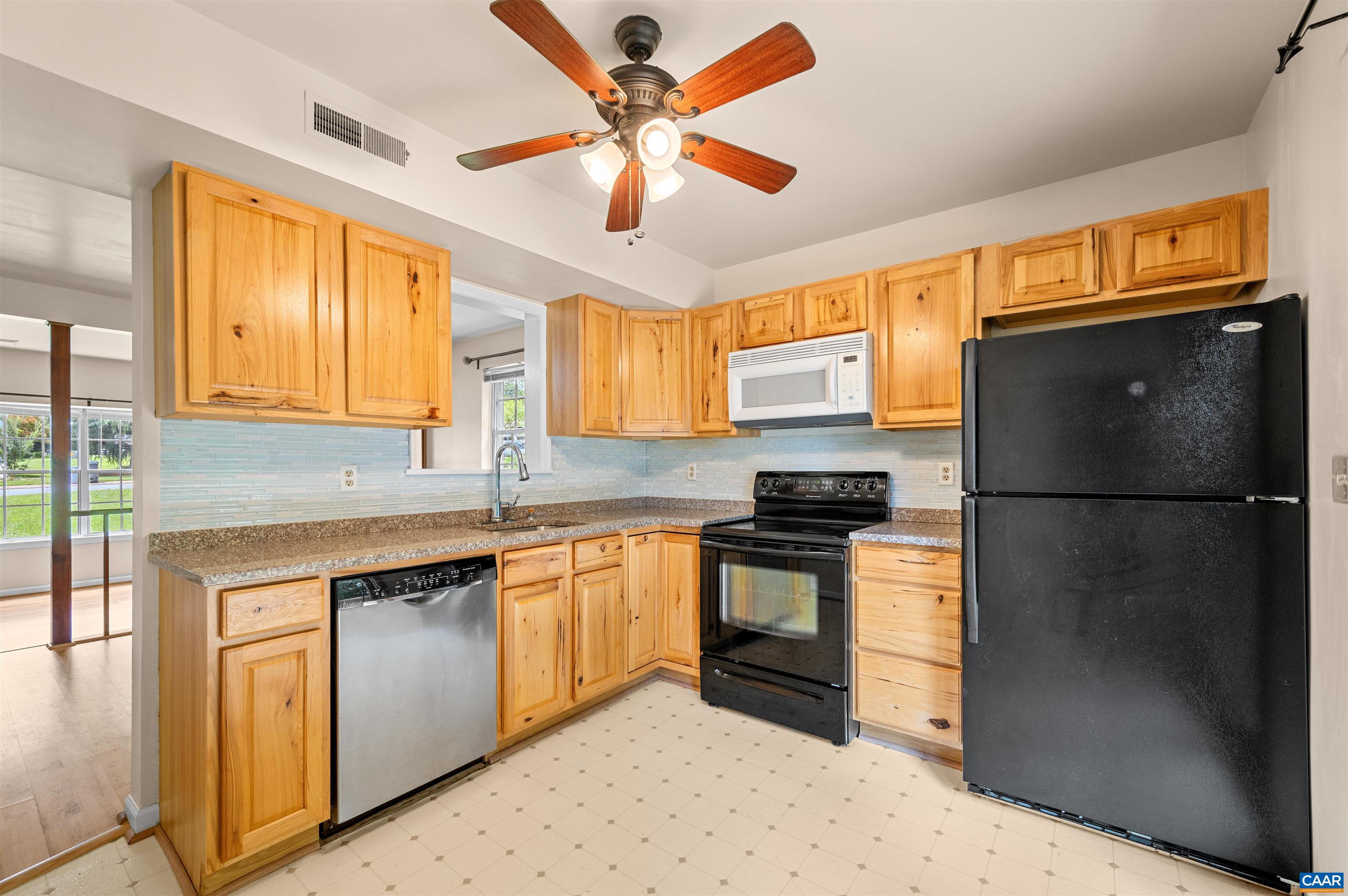 1616 Cool Spring Road Charlottesville, VA 22901 - Photo 12 of 38 a kitchen with stainless steel appliances granite countertop a refrigerator a sink dishwasher a stove and white cabinets with wooden floor