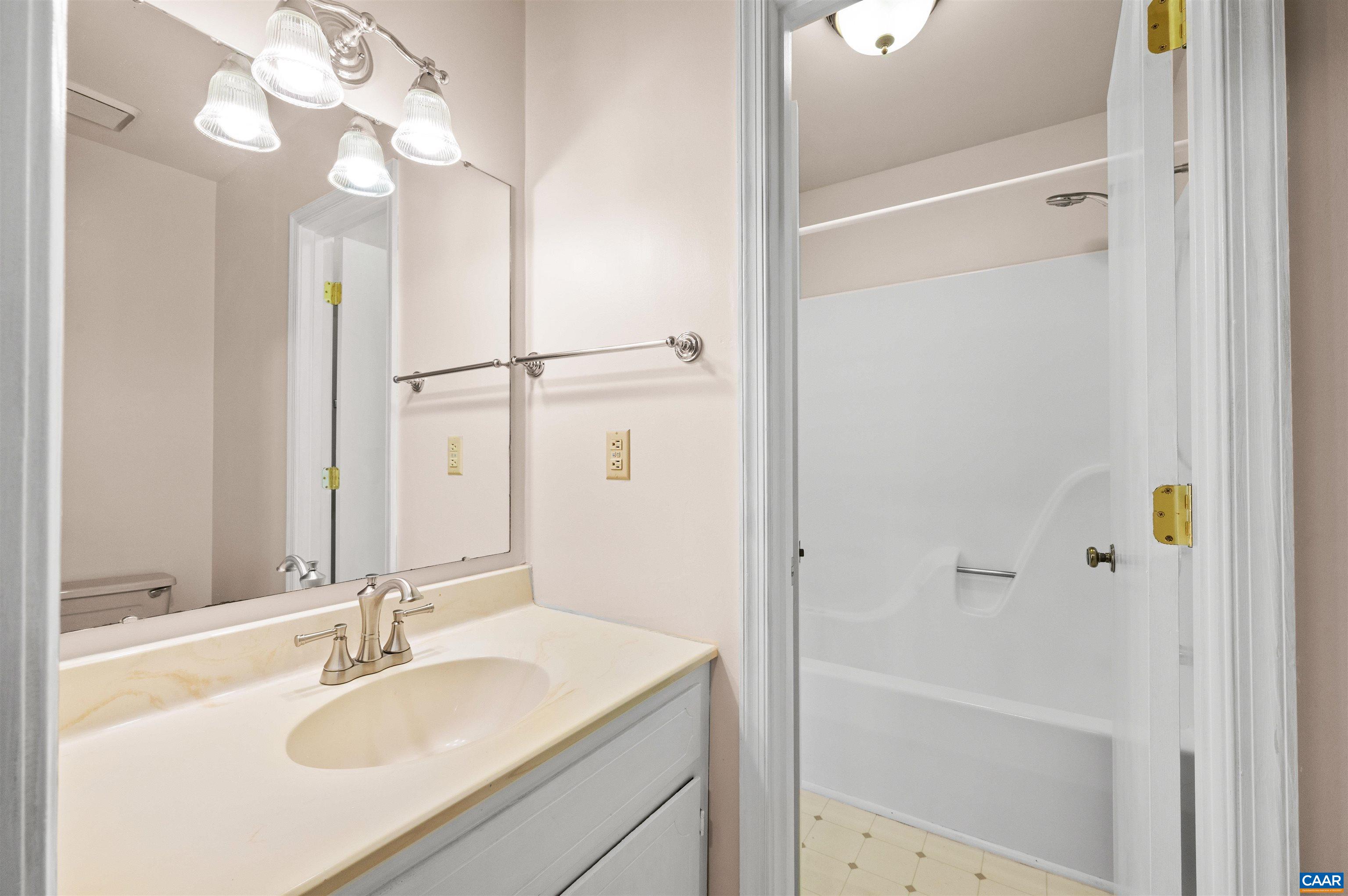 1616 Cool Spring Road Charlottesville, VA 22901 - Photo 30 of 38 a bathroom with a granite countertop sink a mirror and a shower