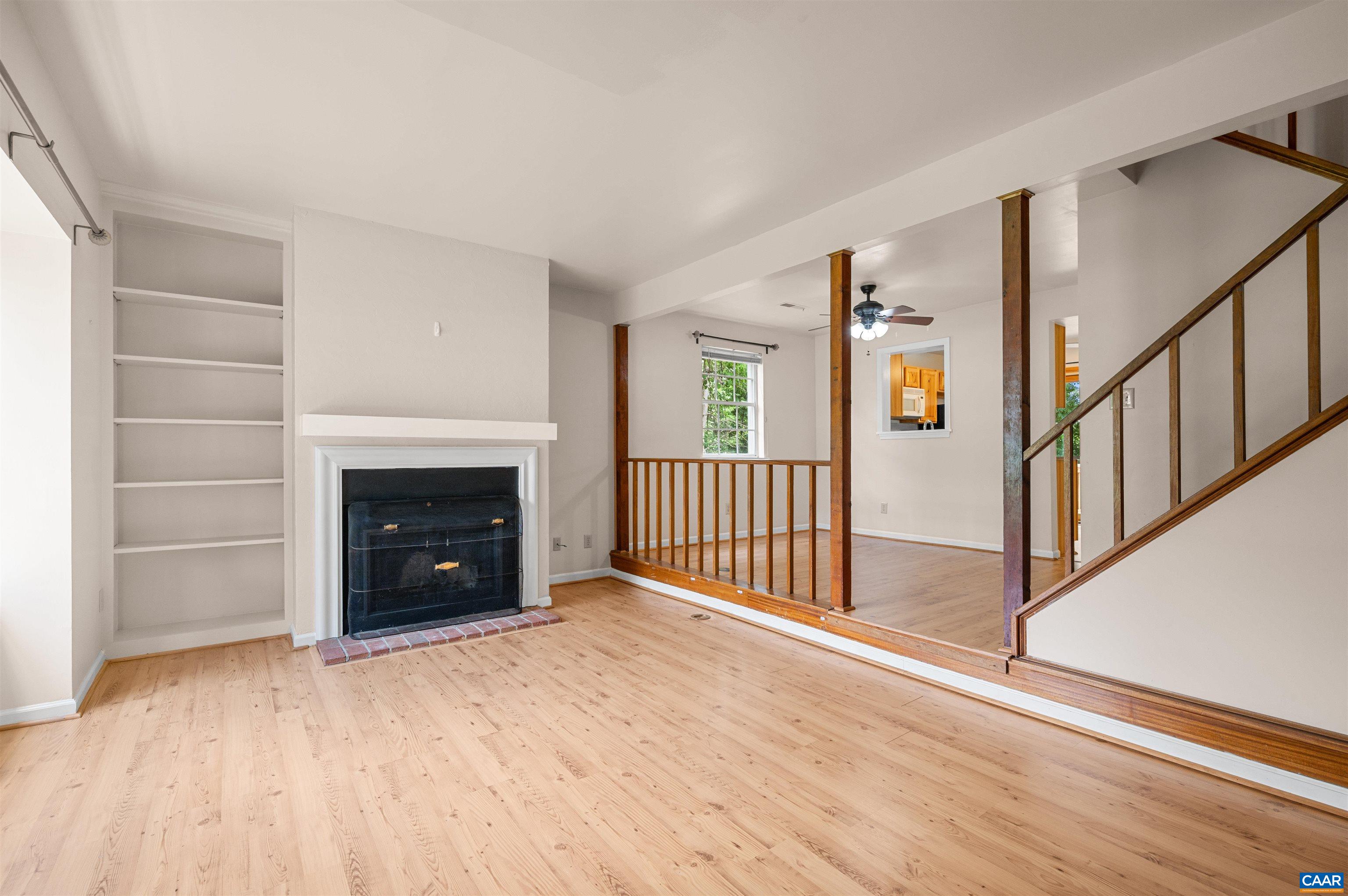 1616 Cool Spring Road Charlottesville, VA 22901 - Photo 6 of 38 a view of an empty room with wooden floor fireplace and a window