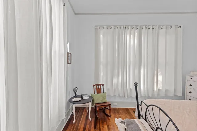 a view of a bedroom with furniture and window