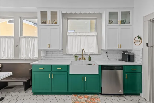 a kitchen with a sink cabinets and a window