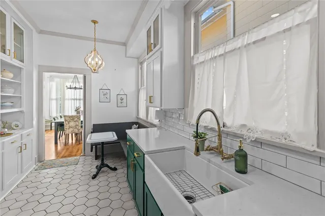 a kitchen with a sink dining table and chairs