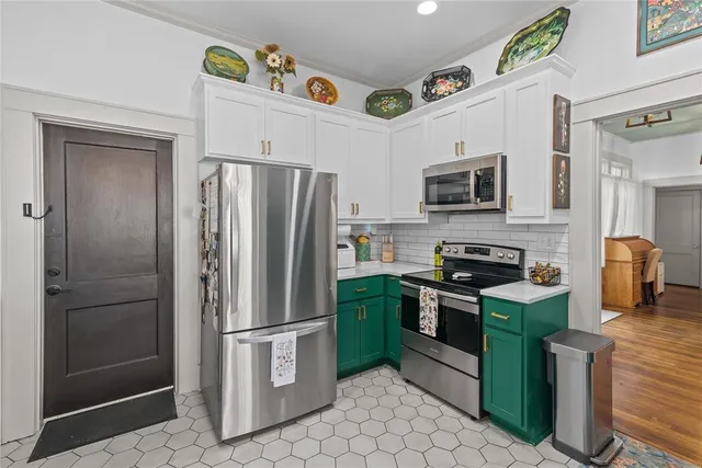 a kitchen with stainless steel appliances granite countertop a refrigerator a stove top oven a sink and dishwasher