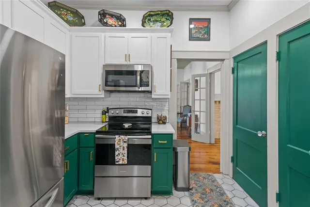 a kitchen with stainless steel appliances granite countertop a refrigerator and a stove
