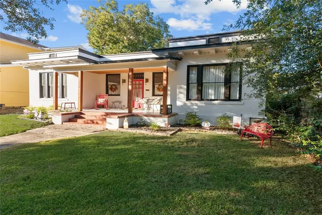 a front view of a house with a yard table and chairs