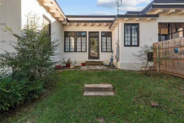 a view of a house with backyard sitting area and garden