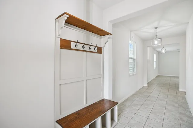 a kitchen with granite countertop a refrigerator and a stove top oven