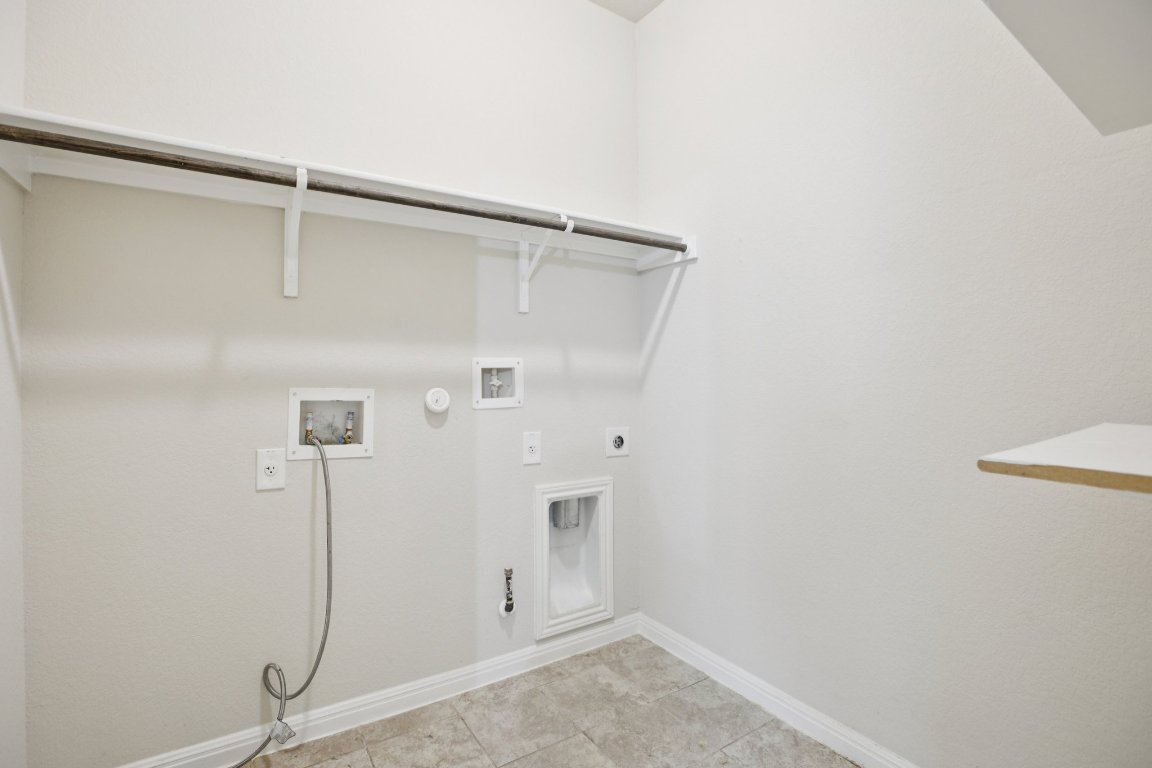 176 Mayney Ln. Leander, TX 78641 - Photo 15 of 34 Washroom featuring hookup for a gas dryer, hookup for a washing machine, electric dryer hookup, and light tile patterned floors