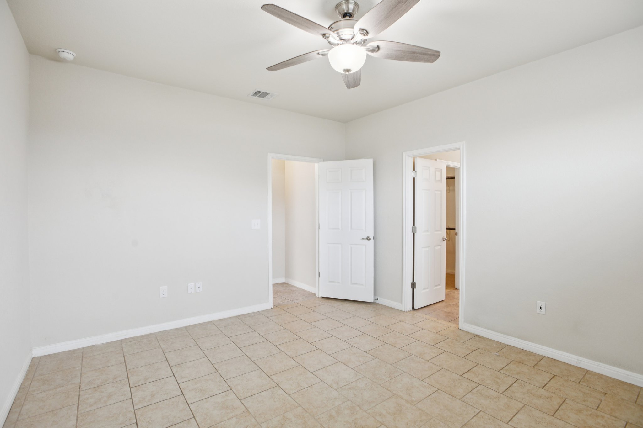 176 Mayney Ln. Leander, TX 78641 - Photo 20 of 37 Unfurnished bedroom featuring ceiling fan and light tile patterned floors