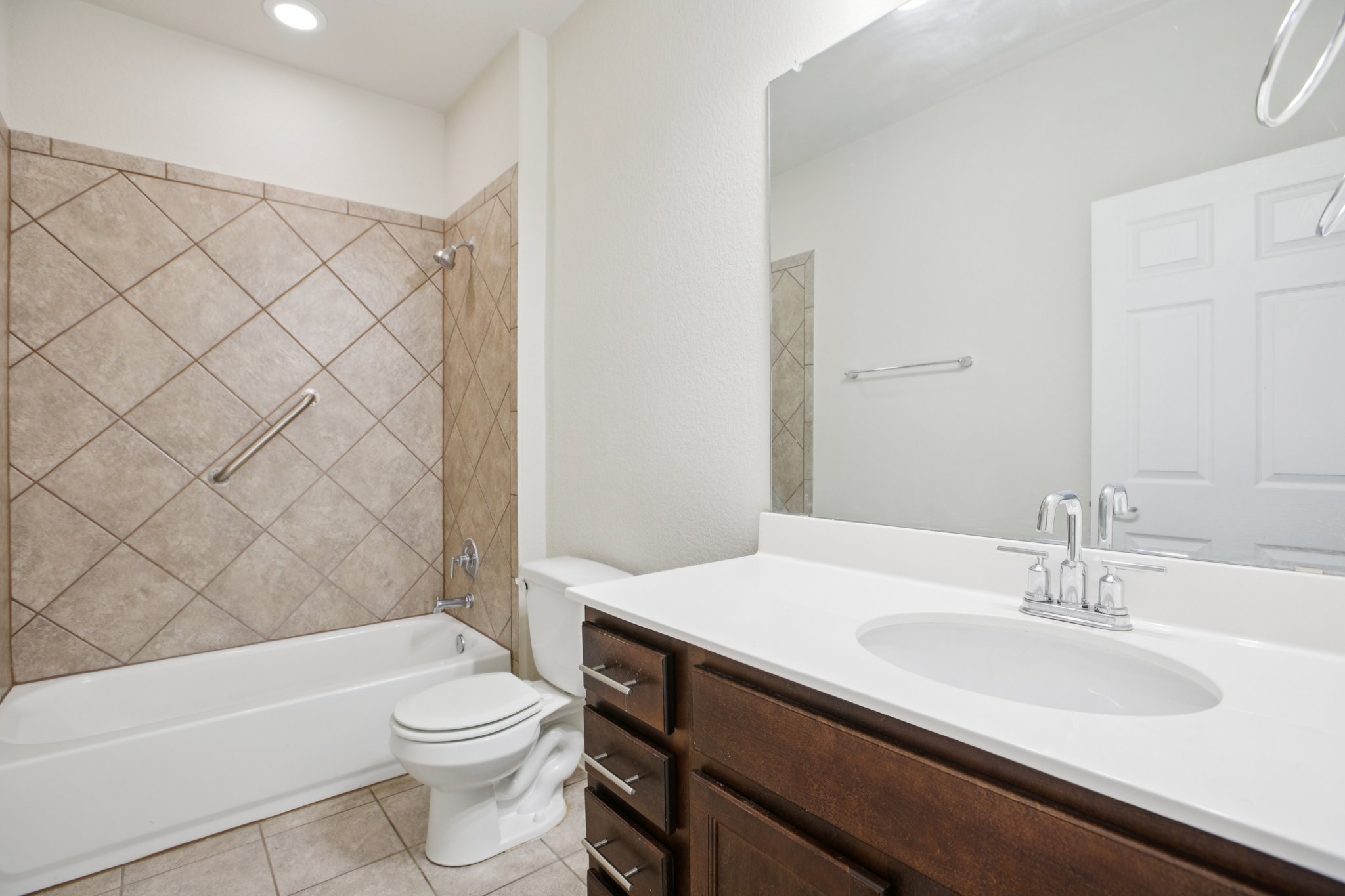 176 Mayney Ln. Leander, TX 78641 - Photo 25 of 37 Bathroom with shower combination, vanity, and light tile patterned floors