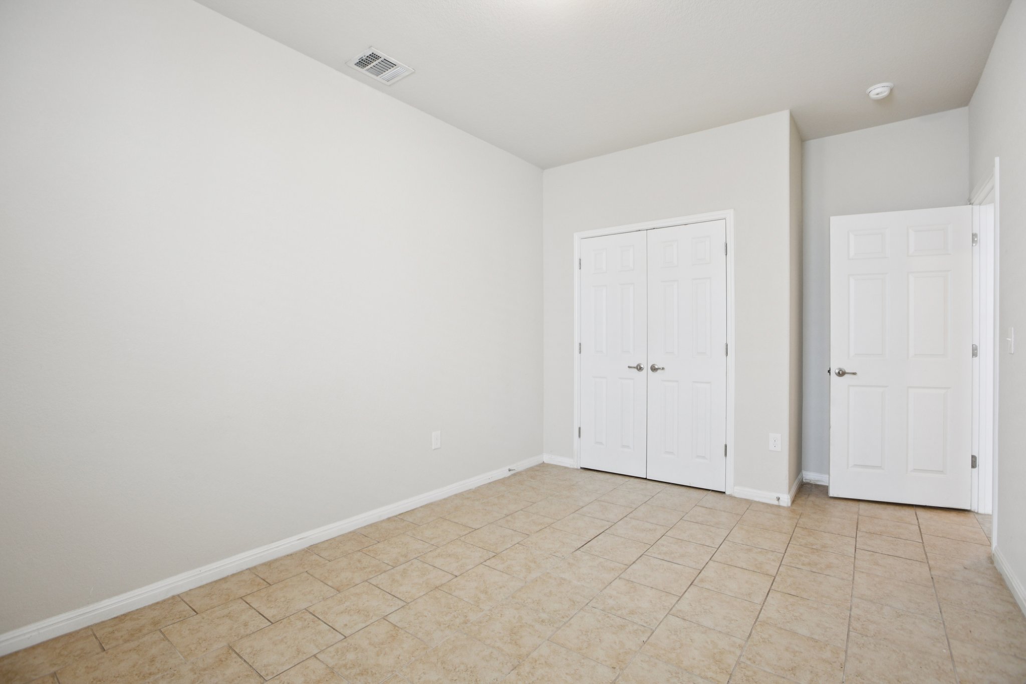 176 Mayney Ln. Leander, TX 78641 - Photo 28 of 37 Unfurnished bedroom featuring a closet and light tile patterned floors