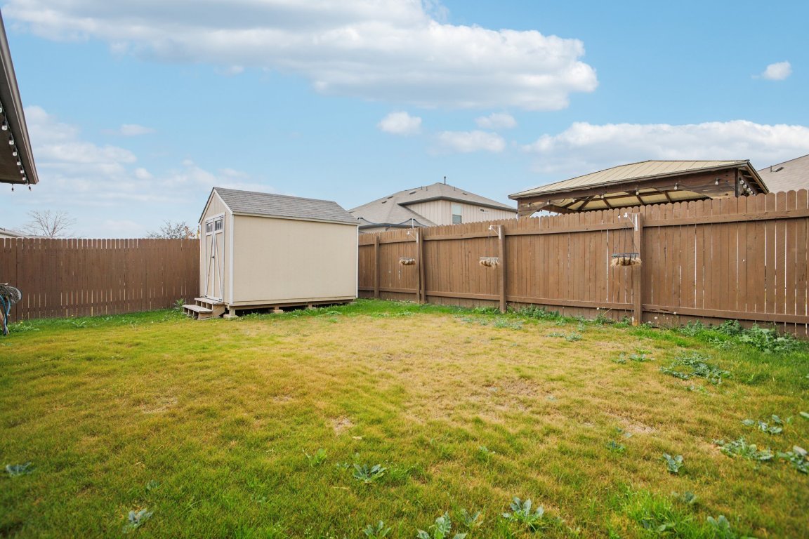 176 Mayney Ln. Leander, TX 78641 - Photo 29 of 34 Fenced backyard with a shed