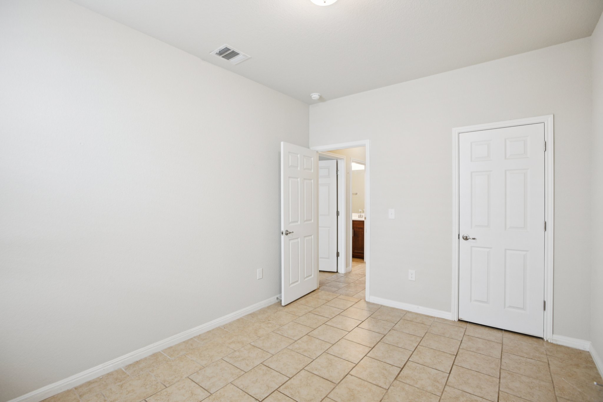 176 Mayney Ln. Leander, TX 78641 - Photo 30 of 37 Unfurnished bedroom featuring baseboards and light tile patterned floors
