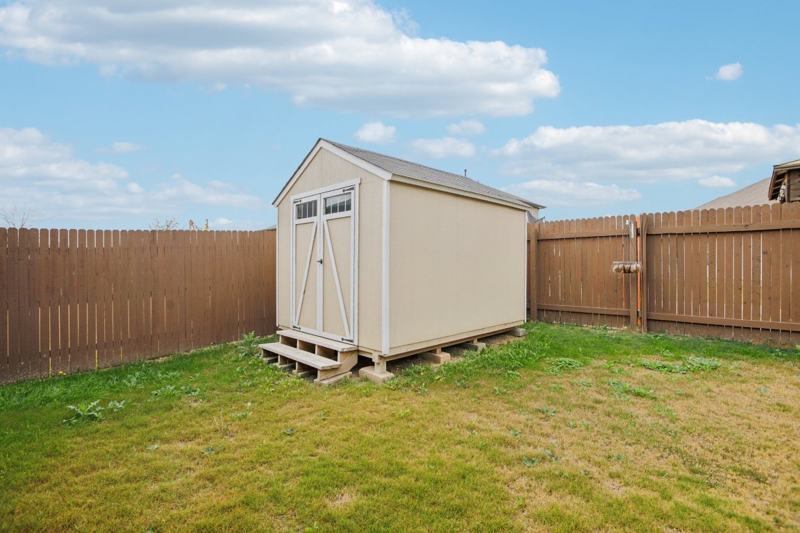 176 Mayney Ln. Leander, TX 78641 - Photo 31 of 34 View of shed featuring a fenced backyard
