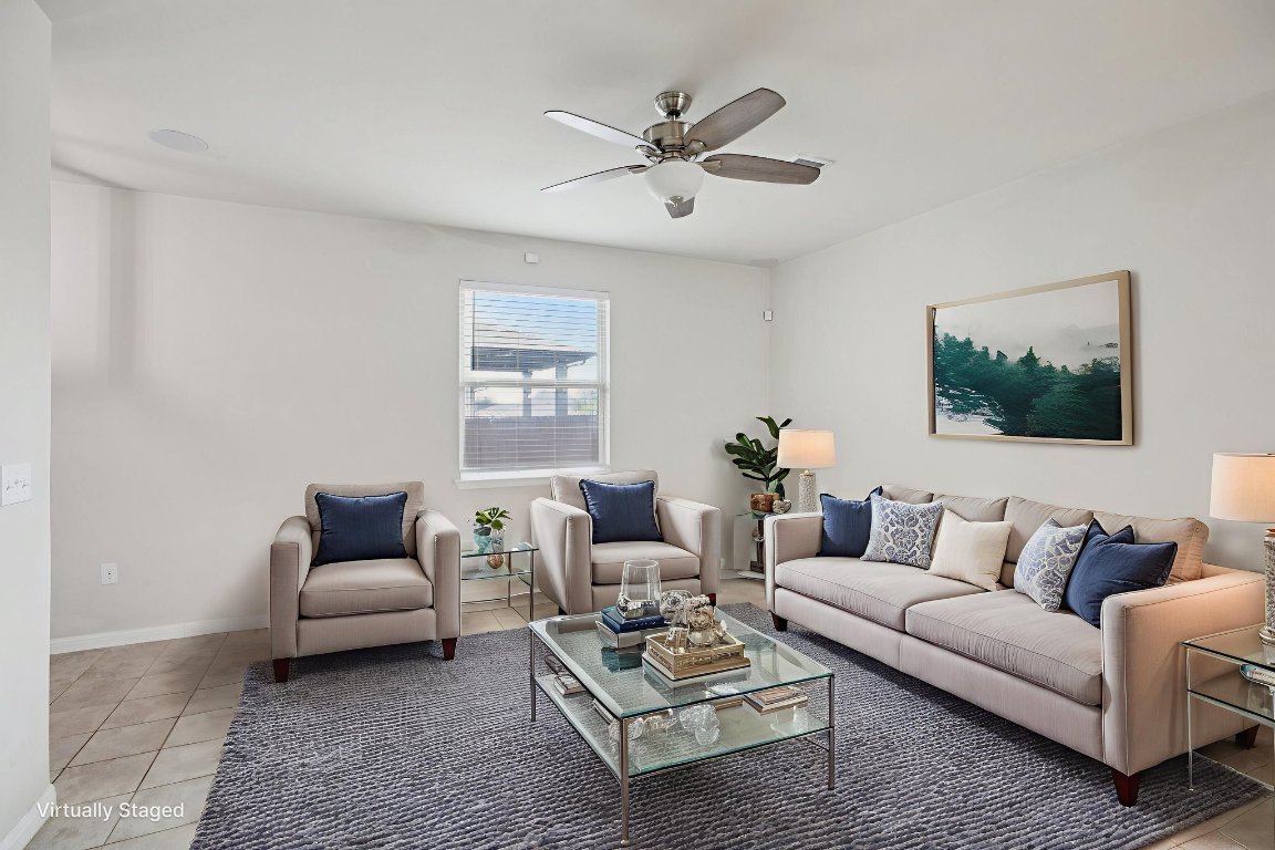 176 Mayney Ln. Leander, TX 78641 - Photo 5 of 34 Living room featuring light tile. Virtually staged