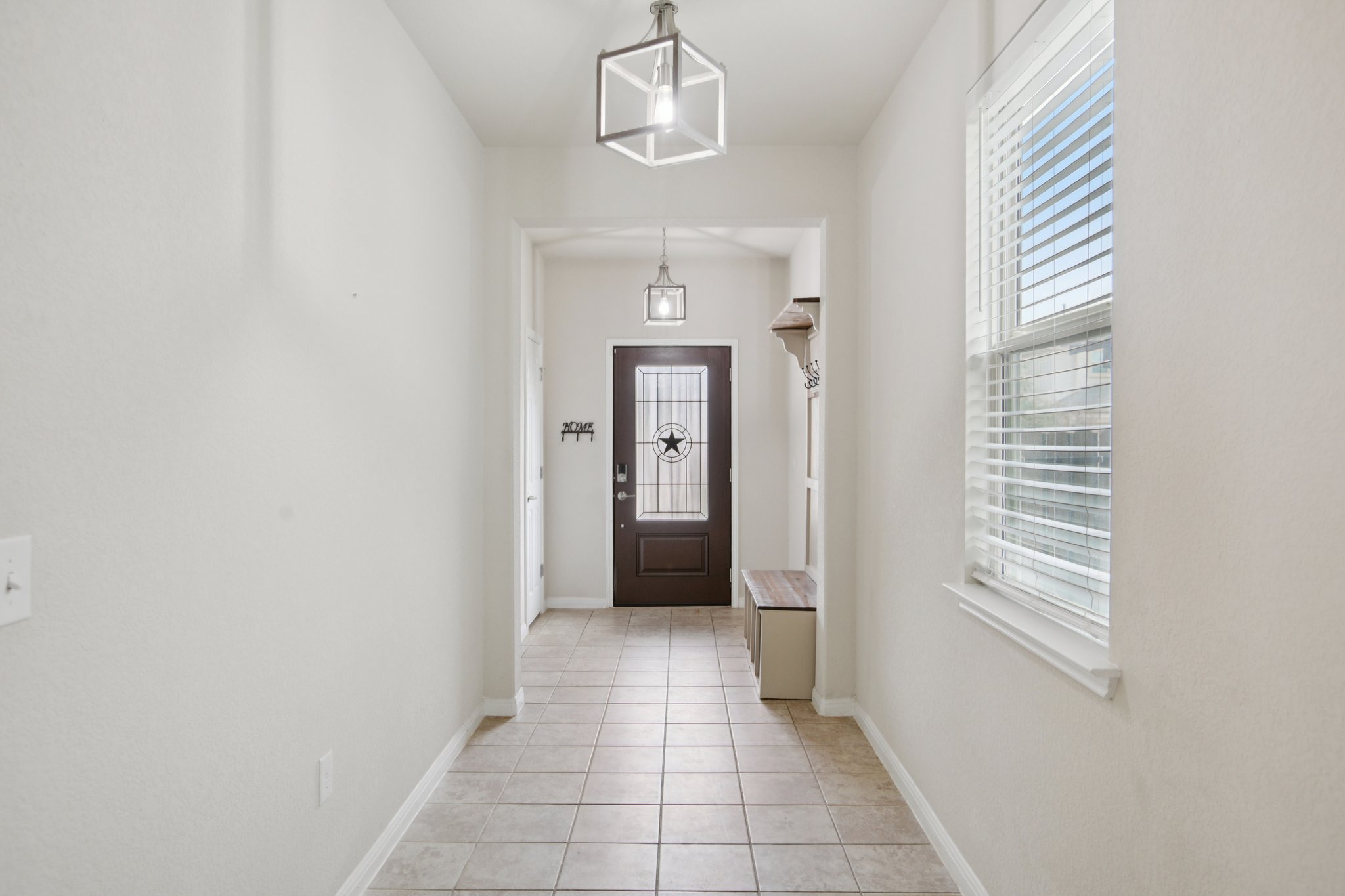 176 Mayney Ln. Leander, TX 78641 - Photo 7 of 37 Doorway with plenty of natural light, tile flooring, shoe & coat bench