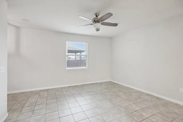 a living room with furniture a rug potted plant and a window
