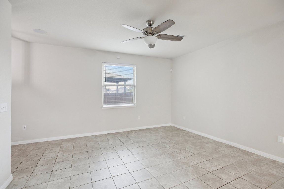 176 Mayney Ln. Leander, TX 78641 - Photo 7 of 34 Unfurnished room with light tile patterned flooring and ceiling fan