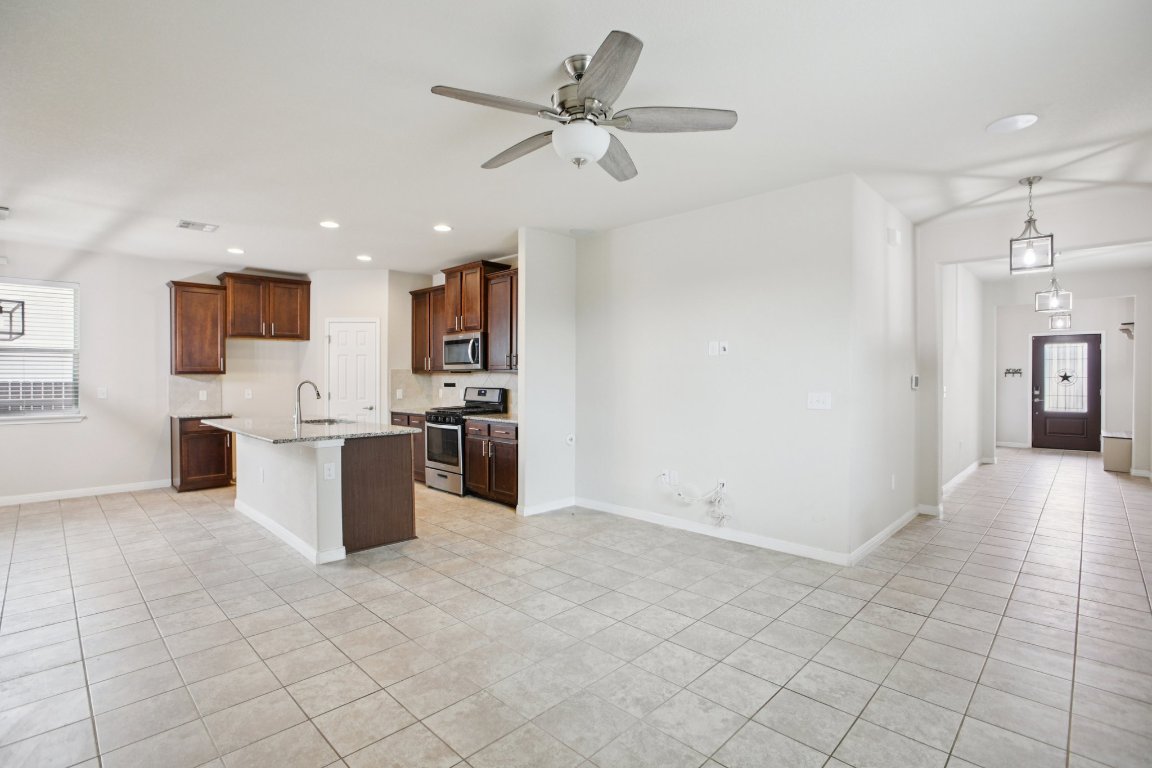 176 Mayney Ln. Leander, TX 78641 - Photo 9 of 34 Kitchen with healthy amount of natural light, decorative light fixtures, stainless steel appliances, and recessed lighting