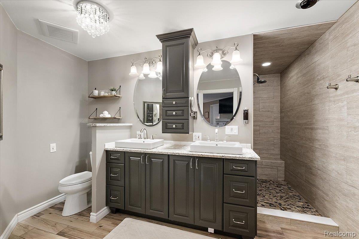 4219 Gardner Road Metamora, MI 48455 - Photo 20 of 84 Dual vanity with vessel sinks, granite-look countertop, and wood-finish flooring