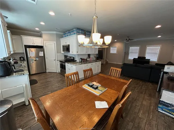 a large kitchen with a table and chairs