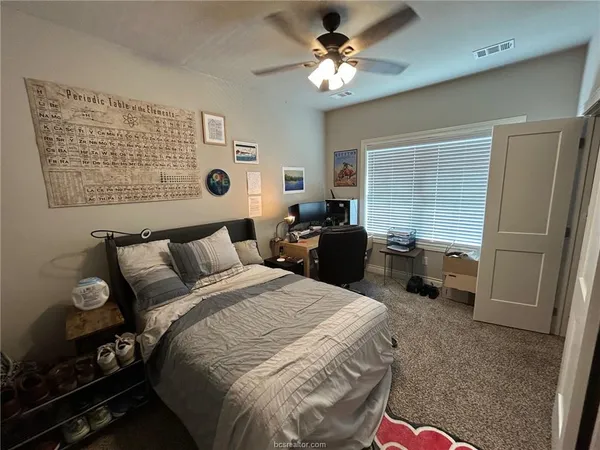 a bed room with a bed dresser and a window