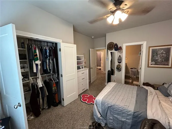 a bedroom with a bed closet and a walk in closet