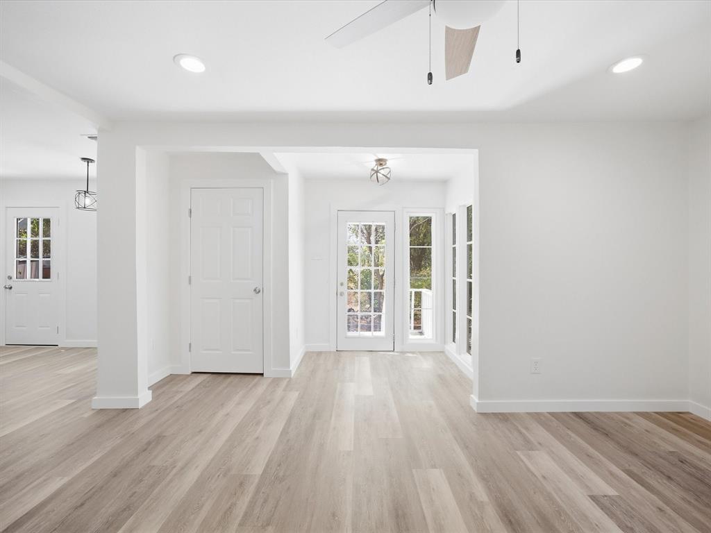 6933 Hatch Road Lake Worth, TX 76135 - Photo 9 of 28 Wood-finish flooring throughout, recessed ceiling lighting, a ceiling fan with light, white paneled doors, and French doors with multiple window panes